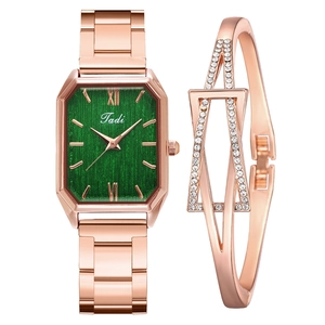 Detail of rose gold rectangular watch with green dial and matching diamond bangle set