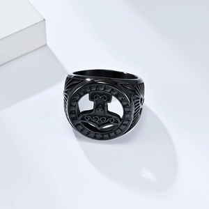 Macro shot of matte black stainless steel ring featuring Mjölnir cutout and side engravings
