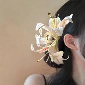 Elegant lily flower hair claw clip in white and pink finish on a classic updo hairstyle