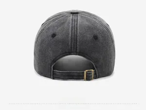 Detail view of washed denim baseball cap back featuring an adjustable brass metal buckle