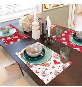 Close-up of heart patterned linen placemats on a wooden table for festive decor