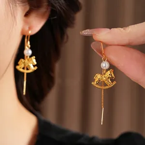 Golden rocking horse threader earrings with white pearl detail for women