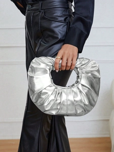 Close-up of metallic silver pleated cloud bag showing glossy PU texture and unique folds