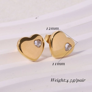 Macro detail of 12mm gold polished heart earrings with inlaid tiny zircon stones