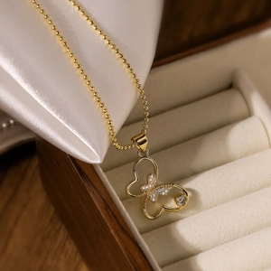 Elegant 18K gold plated butterfly pendant necklace with zircon stones on silk background