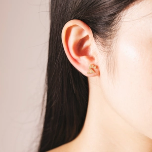 Elegant gold S925 silver LOVE stud earrings with micro-pave crystals on a model