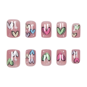 Pink press-on nails with colorful heart graffiti and stars in a short round shape