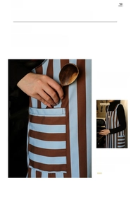 Close-up of retro striped kitchen apron with large front pocket and canvas texture
