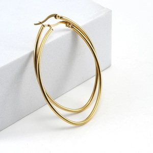 Minimalist golden double circle stainless steel hoop earrings on a white prop