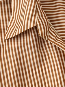 Close-up of brown vertical striped fabric texture and classic shirt collar detail