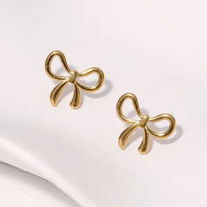 Minimalist gold bow-shaped stainless steel stud earrings on a clean white background