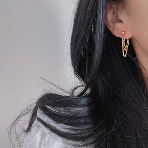 Detail of minimalist double-layer gold chain earrings on model with 18k gold plating