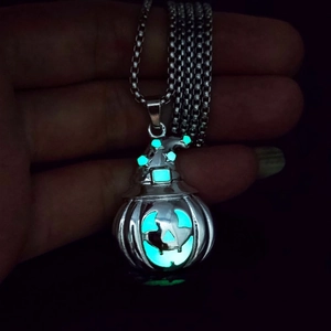 Luminous Halloween pumpkin necklace with wizard hat glowing blue-green in dark