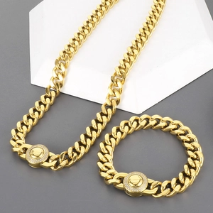 Detail showing 11mm gold Cuban link chain set with diamond encrusted round buckle