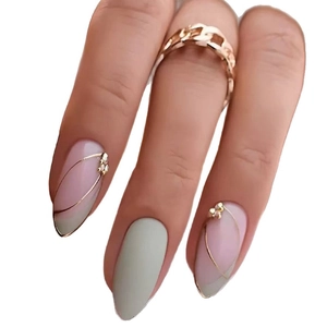 Almond press-on nails in pink and grey-green with gold lines and sparkling rhinestones