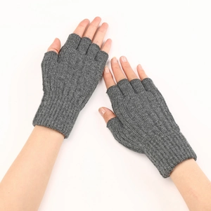 Detail view of grey cable knit fingerless gloves with ribbed cuffs and thumb hole