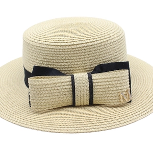 Beige woven boater hat with black ribbon and gold M letter buckle in French style