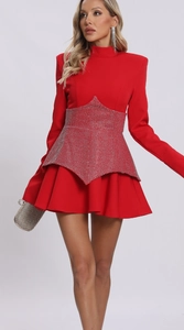 Detail of star-shaped silver rhinestone patterns on a red long-sleeve A-line party dress