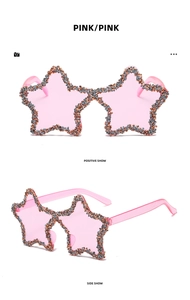Detail of pink star-shaped sunglasses with shimmering crystals and Y2K rimless design
