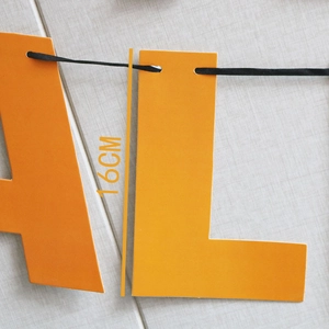 Detail showing 16cm orange Halloween banner letters AL with black ribbon strings