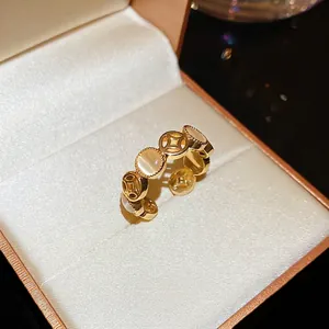 Vintage gold open ring featuring cat eye stones and hollow coin motifs for women