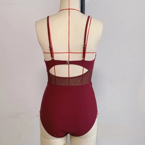 Detail of dark red one-piece swimsuit with adjustable straps and sheer mesh paneling