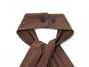 Close-up of dark brown twill fabric with black double-button closure and fine stitching