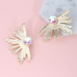 Detailed macro view of golden sunburst earrings with rainbow faceted gemstones