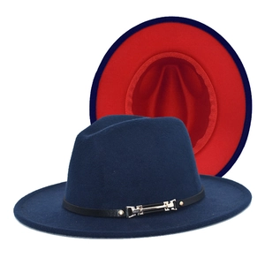 Detail of wool fedora hat with navy blue exterior, red interior, and black leather belt