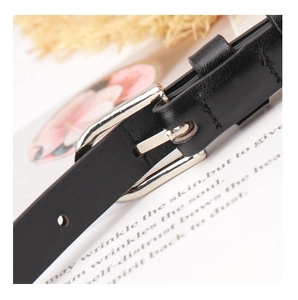 Close-up of black leather belt texture with polished silver metal buckle detail