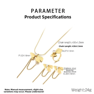 Detailed view of stainless steel bow jewelry set with zircon and tassel details