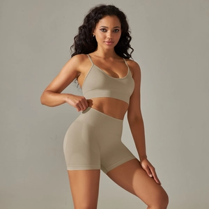 Detail of seamless sandy beige ribbed yoga set with V-neck bra and high waist shorts