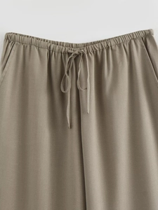 Detail der khakifarbenen Hose mit elastischem Bund und verstellbarem Kordelzug-Design