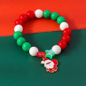 Detailed view of Christmas beaded bracelet with Santa Claus charm and festive red green beads