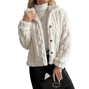 Detail of white plush jacket with cable knit texture and single-breasted button closure