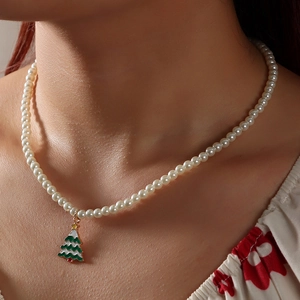 Elegant pearl necklace featuring a green Christmas tree pendant with gold star accent