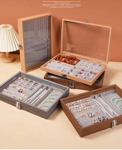 Walnut wood jewelry box with glass lid and multiple compartments for rings and necklaces