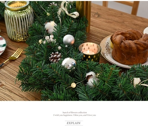 Christmas garland featuring pine cones, silver baubles, and cotton with warm LED lights