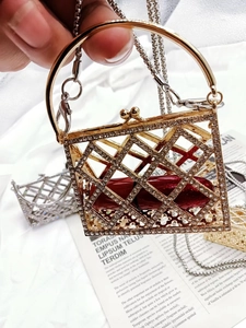 Close-up of gold rhinestone grid mini bag with chain strap and lipstick inside