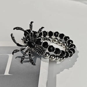 Detailed shot of gothic spider bracelet featuring black crystals and silver beaded chains