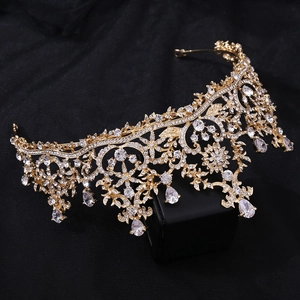 Macro detail of golden bridal crown with sparkling AAA zircons and drop-shaped crystals