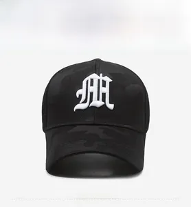 Detailed embroidery of white gothic letters on a camouflage patterned baseball cap