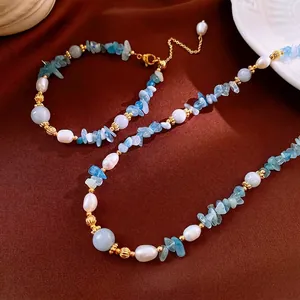 Elegant pearl and blue aquamarine gemstone necklace set with gold metallic accents