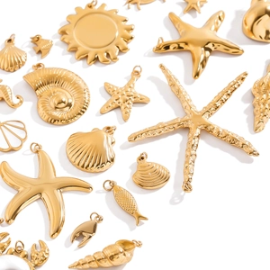 Detailed flat lay of golden stainless steel sea life pendants including starfish and shells