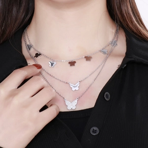 Close-up of triple-layered silver butterfly pendant necklace with sparkling crystal inlay