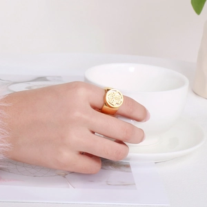 Detailed view of a golden Hamsa hand ring worn elegantly during a stylish tea time