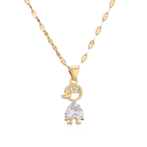 Macro detail of heart-shaped crystal pendant and zircon-encrusted figure on gold necklace