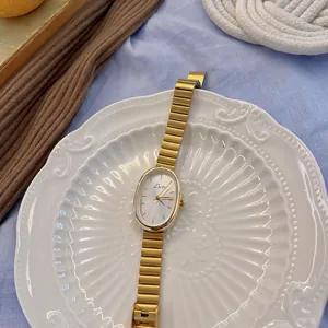 Elegant gold vintage quartz watch for women with oval dial and metal chain strap