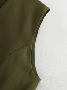 Detailed close-up of olive green asymmetric vest showing high-quality stitching and woven fabric