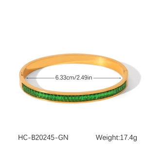 Detail shot of 18K gold plated stainless steel bangle with emerald green zircon inlay